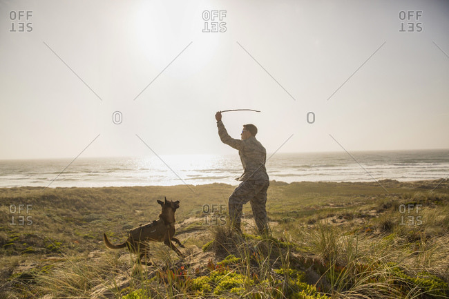 Soldier playing fetch with his Military Service Dog