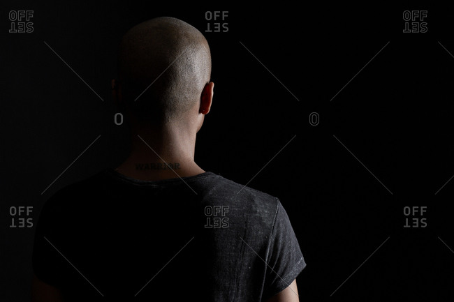 Back of a young woman with a shaved head