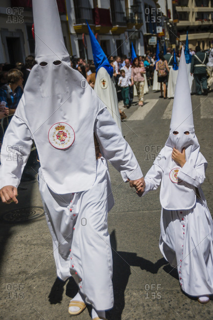 Father and son in capirotes during the Holy Week in Sevilla, Spain