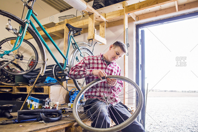Man repairing wheel on a bicycle