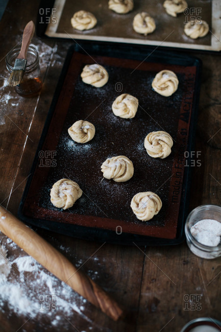 Cinnamon buns arranged on a baking pan