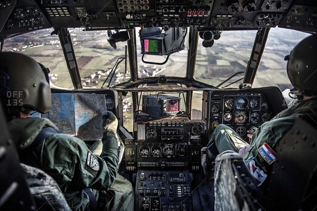 View of two Mi-17 helicopter pilots flying above Kosovo
