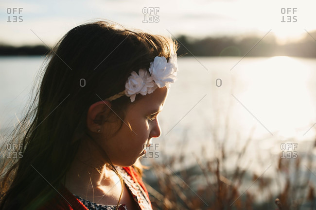 Girl wearing a floral headband in the late afternoon sun