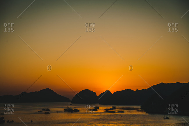 Silhouette of boats in a harbor at sunset