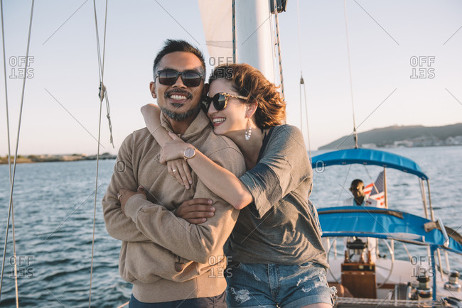 Couple embracing while enjoying view on sailboat, San Diego Bay, California, USA