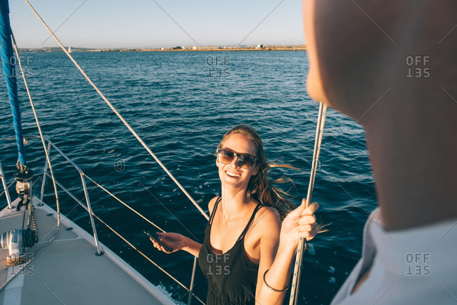 Woman chatting with friend on sailboat, San Diego Bay, California, USA