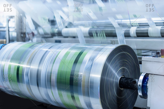 Large roll of printed plastic film in food packaging printing factory