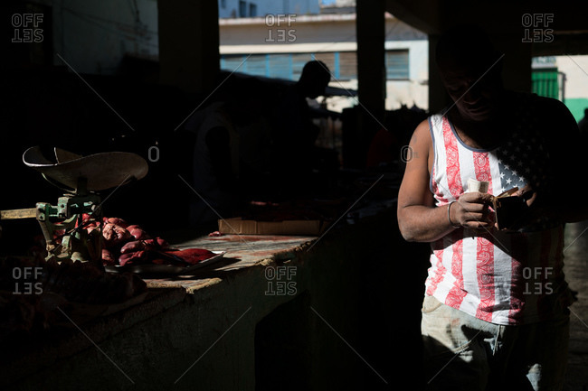 Man counting money at outdoor market