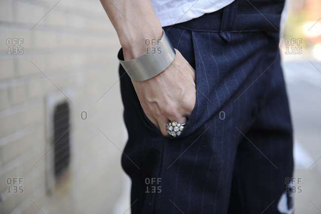 Woman in blue pinstripe pants with her hand in her pocket