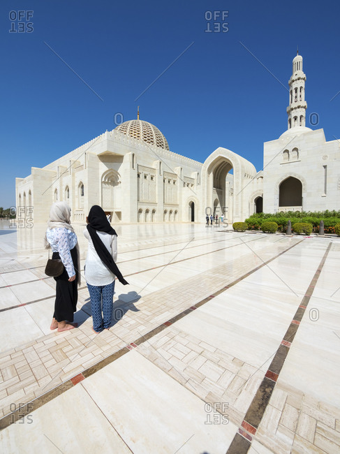Two wonem walking at Sultan Qaboos Grand Mosque in Oman
