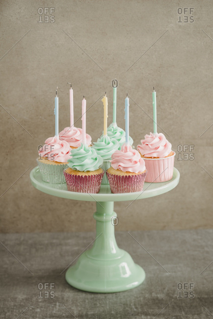 Cup cakes with candles on a cake stand