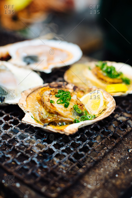 Food stall with grilled scallops, lemon and spring onions, Japan