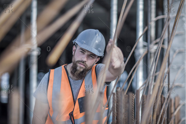 Site manager signaling with hand on construction site