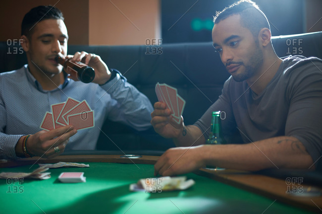 Men playing card game for cash at pub card table