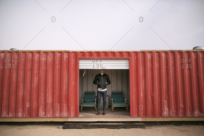 Man standing in a red shipping container