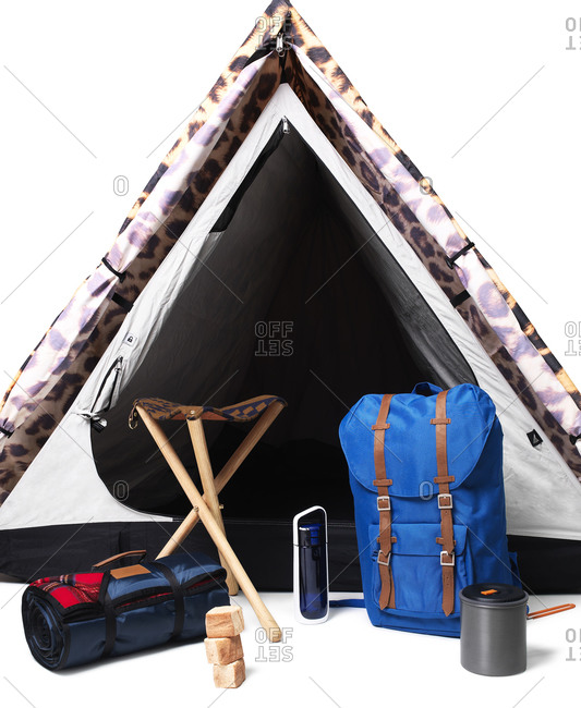 Camping gear in front of tent on white