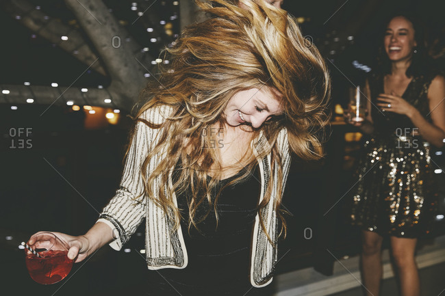 Woman at a party waving her hair in the air