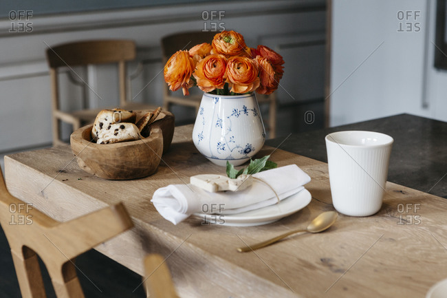 Orange peonies on a wooden table