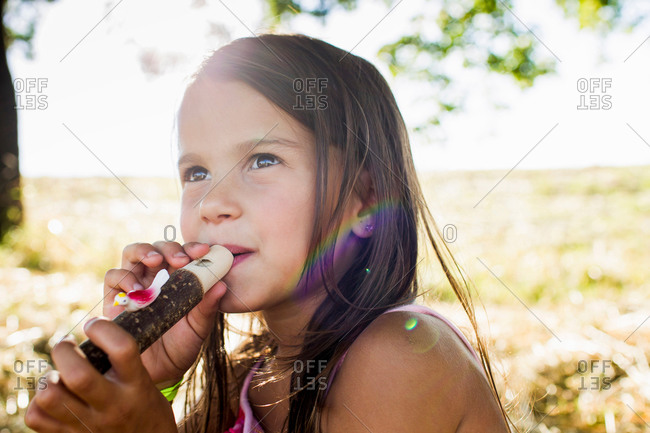 Portrait of girl blowing bird whistle in park