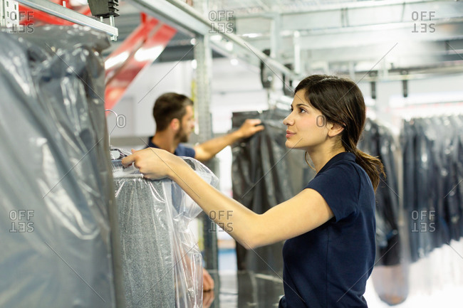 Warehouse workers preparing garment orders in distribution warehouse
