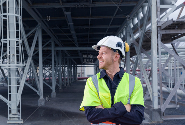 Engineer looking away from warehouse space at geothermal power station