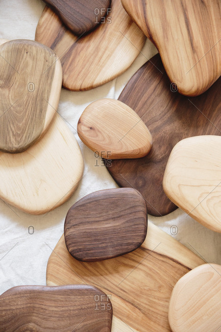 A collection of small smooth turned wooden objects of different shades and wood grain patterns