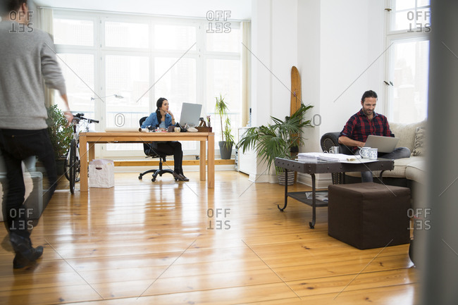 Three creative business people working in informal office
