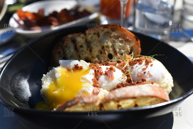 Poached eggs and toast on a large ceramic plate