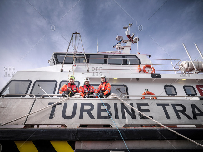 Portrait of offshore windfarm engineers in port on ship