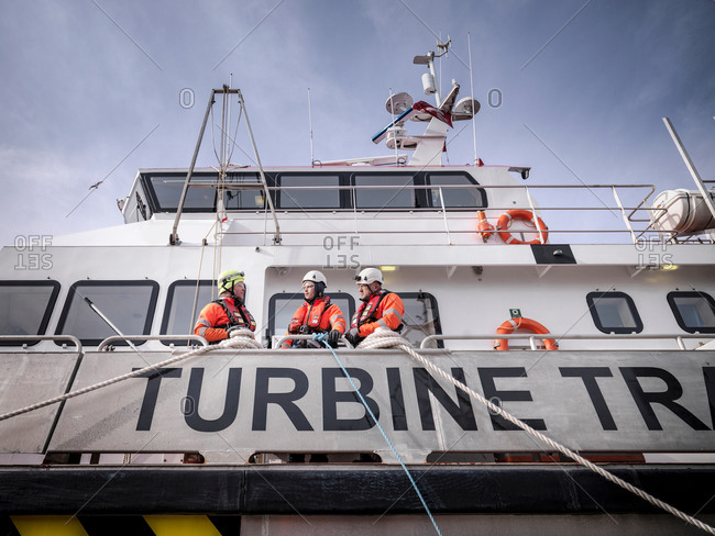 Offshore windfarm engineers in port on ship