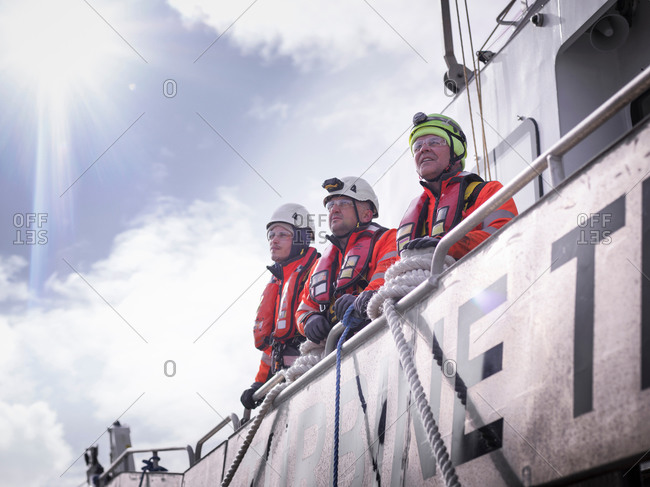 Offshore windfarm engineers in port on deck of ship