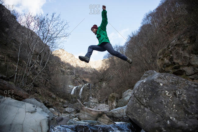 Man jumping over Toce River, Premosello, Verbania, Piedmont, Italy