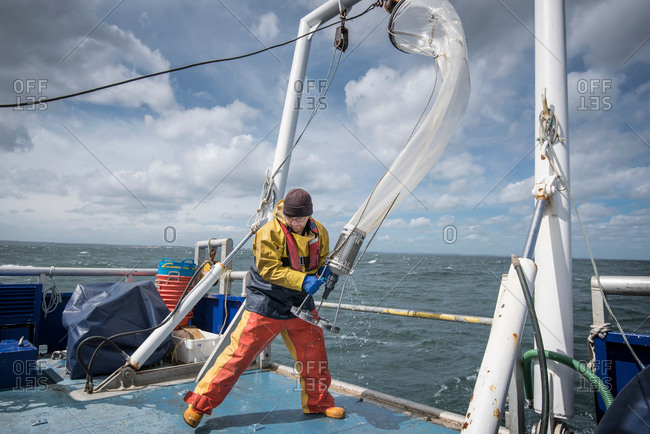 Scientist bringing plankton net on board of research ship