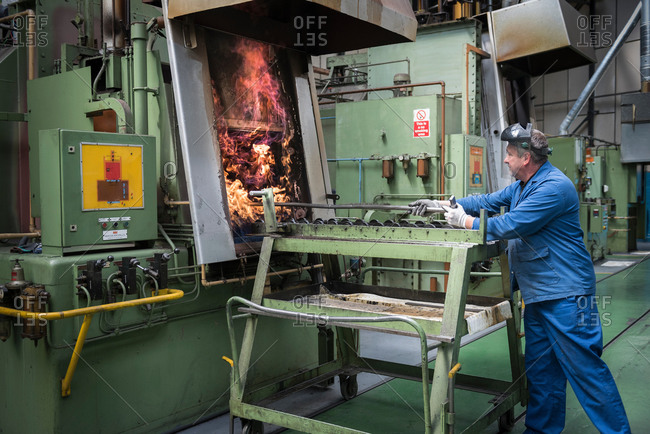 Engineer heat treating gear wheels in engineering factory