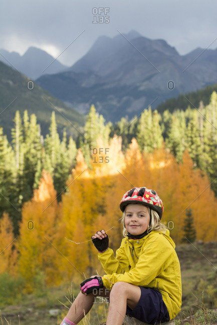 A young girl mountain biking in the San Juan National Forest, Silverton, Colorado.