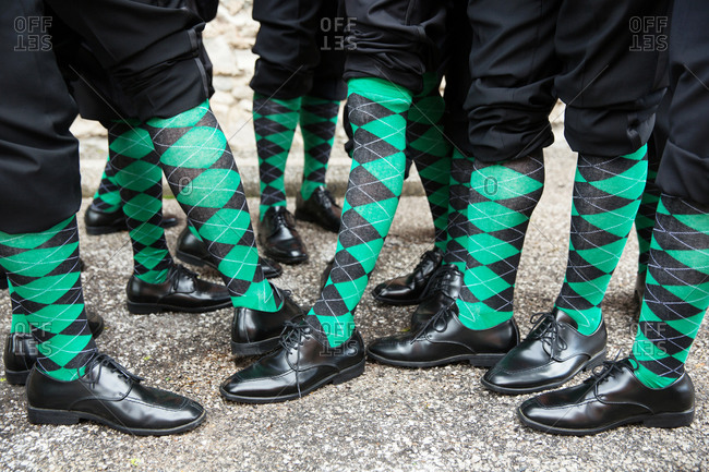 Groomsmen showing off green and black socks