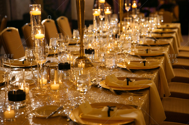 Long table set with candles, flowers, and table runner