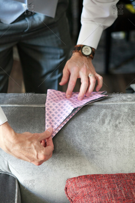 Man folding a colorful pocket square