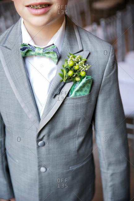 Close-up of a ring bearer\'s boutonniere and pocket square