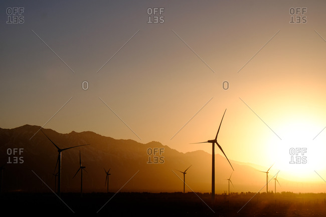 Windmill electricity generators on a wind farm at dusk