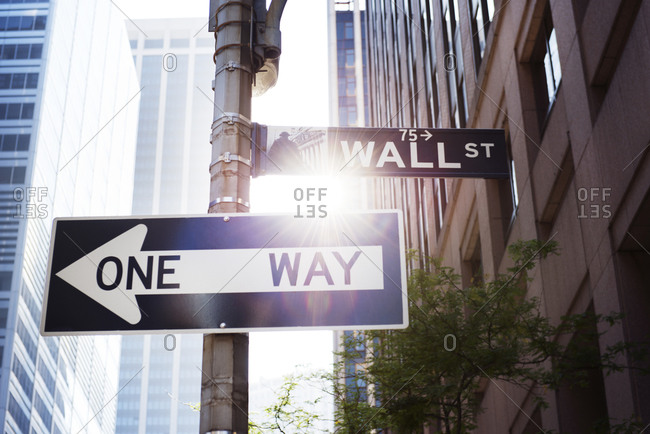 Street sign of Wall St and a one way sign, New York City, NY