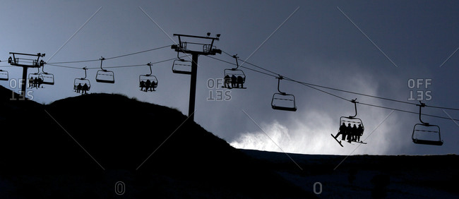 Panoramic view of the ski lifts and a snow machine blowing snow at Coronet Peak, Queenstown,  South Island, New Zealand