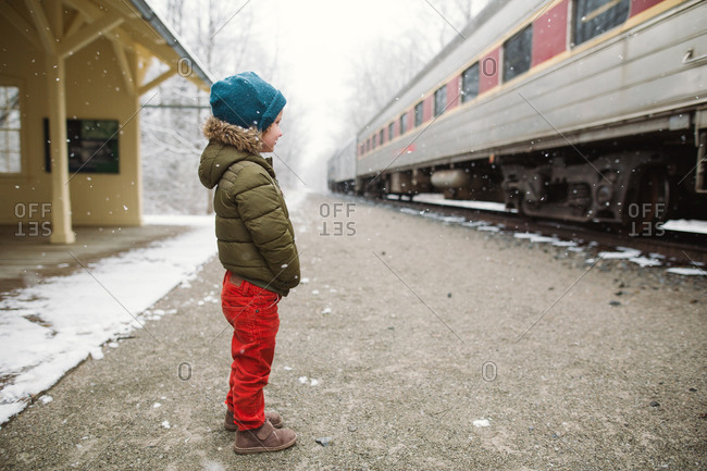 Boy on train platform in snow
