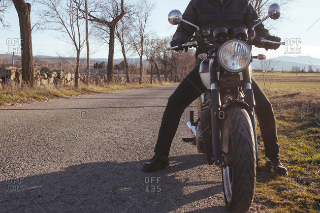 Front view of a motorcycle rider on a country road