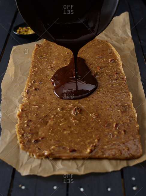 Chocolate topping being board on brittle candy
