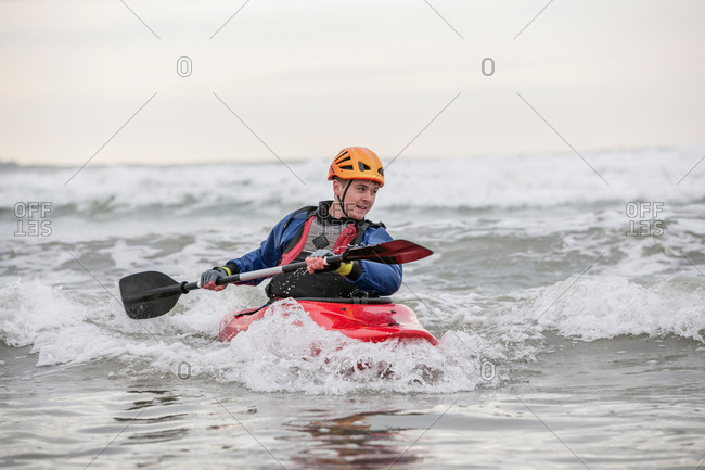 Young man sea kayaking