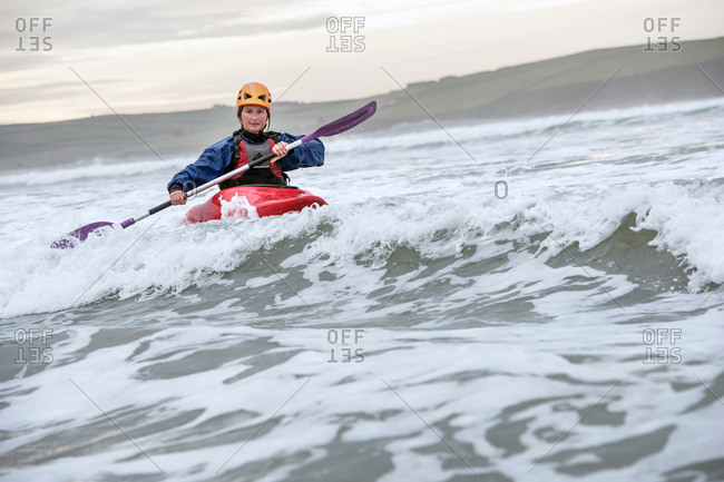 Mid adult woman sea kayaking