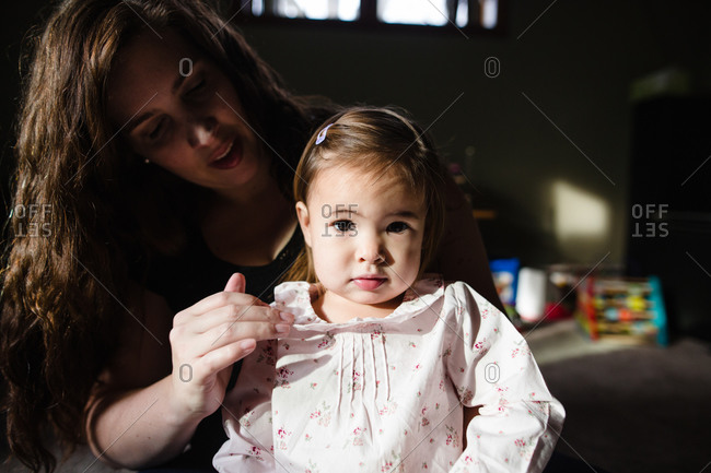 Mother adjusting the collar of daughter�s shirt