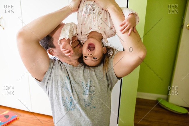 Daughter being held upside down
