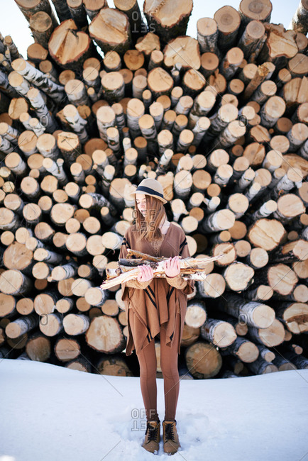 Woman with wood by logs